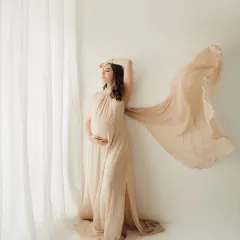 Every mother deserves to feel like a goddess. This shot, with the flowing fabric of a gown from my client wardrobe, captures the power and grace of pregnancy. We use natural light and simple props to create fine art maternity portraits like this.