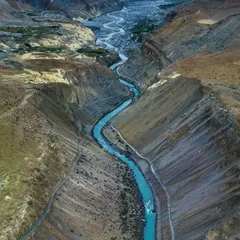 The Spiti River, a ribbon of turquoise flowing through the rugged Himalayan desert. Capturing this view required finding the perfect vantage point to show the river's journey through the vast canyon.