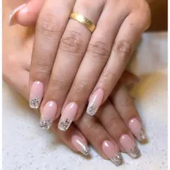 A touch of sparkle can elevate any look. For this manicure, I created a beautiful gradient of silver glitter over the tips of these long, square-shaped extensions, blending into a natural pink base.