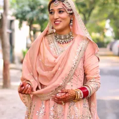 A candid shot of the bride, her smile radiating pure joy. The makeup is light and fresh, ensuring she feels comfortable and looks naturally beautiful.