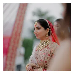 A beautiful, candid portrait of the bride during the ceremony. Her calm expression and elegant attire are captured in soft, natural light.