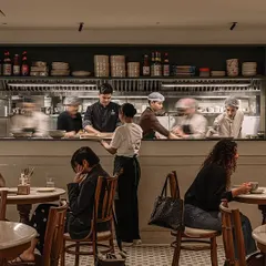 I always wanted Kopitiam Lah to have the lively, bustling energy of a real Malaysian coffee shop. Here you can see my amazing team at work in our open kitchen, preparing authentic dishes for our guests. The sounds and smells are all part of the experience.