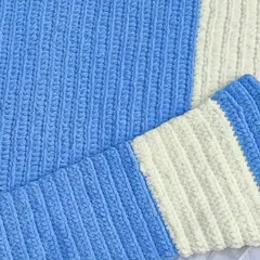The finished baby blanket folded, highlighting the clean lines of the striped pattern.