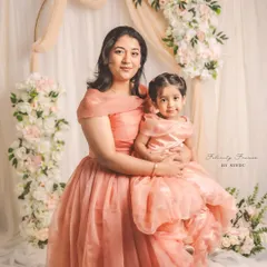 Creating memories stitched with love. This enchanting mother-daughter duo, Meghana and her little one, are twinning in elegant peach organza gowns I designed for their special Mother's Day photoshoot.