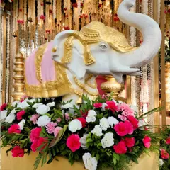 We incorporate traditional motifs with elegance, like this beautifully adorned elephant statue. Placed amidst a bed of pink and white flowers, it adds a touch of royal grace to the wedding decor.
