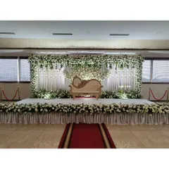 A wide shot of the all-white floral stage.