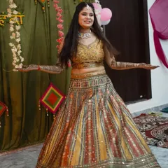 A happy bride-to-be twirling in a multi-color striped lehenga for her Mehendi ceremony. The vibrant colors and playful design are perfect for the occasion.
