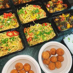 An Asian feast packed for a house party. This delivery included our vegetable hakka noodles, chili chicken, and crispy arancini balls.