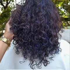 A look at the freshly done hair color on her curls. The purple is vibrant and coats each curl beautifully.
