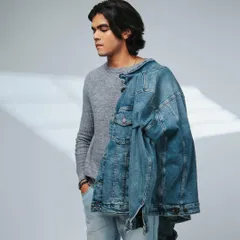 A relaxed pose showing the model with the jacket slung over his shoulder. This adds a touch of effortless cool to the series.