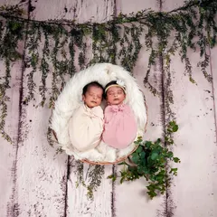 Double the joy with a twin newborn shoot. We posed these two sleeping angels together in a rustic basket, highlighting their special bond from the very beginning.