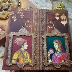 For a love story that feels like royalty, I designed this invitation inspired by timeless Indian miniature art. The Raja-Rani window portraits, set against a rich, textured background, create a regal and intimate announcement for your grand celebration.
