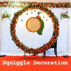 A beautiful floral ring backdrop for a naming ceremony. The setup includes a peacock prop and traditional lighting, creating a perfect setting for the special occasion.
