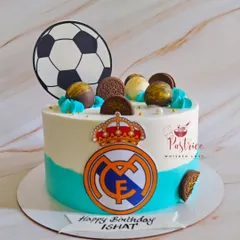 A Real Madrid football-themed cake for a true fan, featuring the team's logo and a soccer ball topper.
