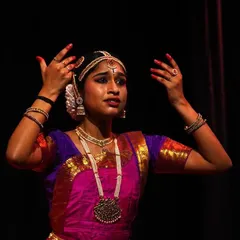 A senior student captured in a moment of expressive storytelling. Her hand gestures and facial expression work together to convey the emotion of the piece.