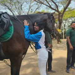 A rider shares a hug with her equine partner. These moments of affection are a daily sight at our academy and are a huge part of the joy of riding.