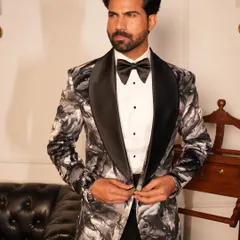 The Concerto Tuxedo features a dramatic black and white abstract pattern, perfect for the gentleman who wants to express his artistic side. The satin shawl lapel adds a touch of classic formality.