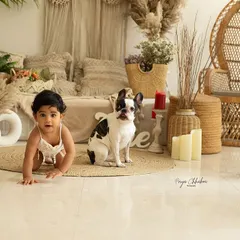 A baby and her best furry friend exploring the studio together. Including pets in milestone photoshoots adds an extra layer of love and personal history to your memories.