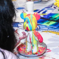 A close-up of a completed fluid bear, showcasing the vibrant and unique patterns created by the guest.