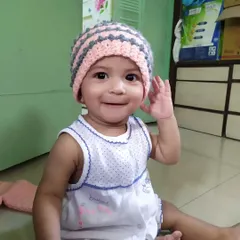 My daughter wearing the Dewdrops Beanie. It’s designed to be snug and warm, and the striped pattern with textured stitches makes it a really cute winter accessory.