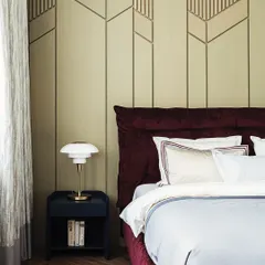 Luxury redefined. This bedroom concept shows how a textured wall panel behind the bed can create a stunning focal point. The combination of a deep red velvet bed and a geometric wall design is pure elegance.