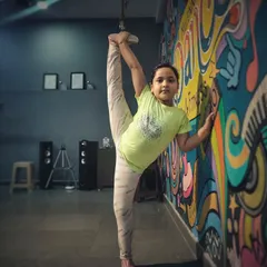 We help kids discover what their bodies are capable of. Here, one of my dedicated students shows incredible flexibility during a stretching session at our studio, proving that with practice, you can stretch your limits.