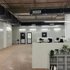 This image shows the raw, industrial aesthetic of the space before full furnishing, highlighting the exposed ceiling with HVAC ducting and the insulated PUF panel walls we supplied and installed.
