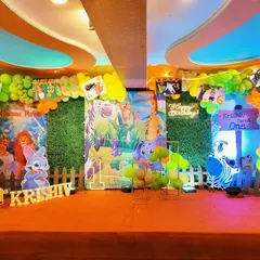 We create a complete stage look for your child's wild one birthday. This jungle theme includes a lush green grass backdrop, colorful balloon garlands, and multiple animal character cutouts to set the scene.