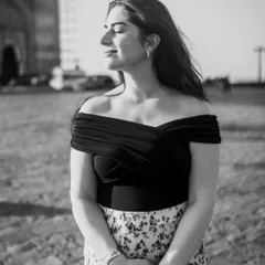 A serene black and white shot, capturing a quiet moment of reflection. The gentle breeze and closed eyes create a sense of peace and calm.