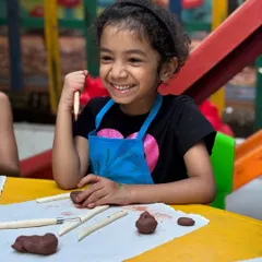 The pure joy of creation! This young artist's smile captures the fun and engaging atmosphere of my clay modelling workshops.