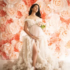 A vision of grace against a wall of blooming flowers. This textured gown and floral backdrop come together to create a portrait that is both romantic and deeply elegant.