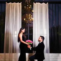 For a chic and sophisticated look, nothing beats classic black. This couple chose our black velvet slit gown and a matching velvet tuxedo for their pre-wedding photoshoot, creating an aura of timeless glamour.