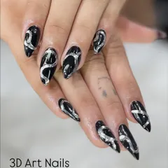 Bold and dramatic 3D art. I used a silver metallic gel to create these raised, swirling patterns over a glossy black base on long stiletto nails.