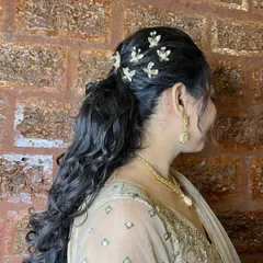 A view from the back, showing the detail of the butterfly clips and the volume of the curls.