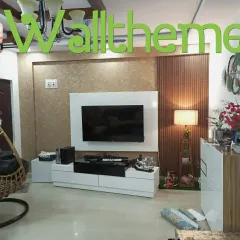 A textured, sand-colored wallpaper installed on a media wall, creating a subtle yet sophisticated backdrop for the television and decor.