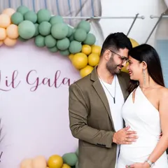 A quiet moment of connection for the parents-to-be at their baby shower. The soft, modern decor with the "Lil Gala" sign provides a beautiful backdrop for this intimate portrait.
