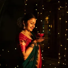The magic of Diwali captured in a single frame. I used the warm glow of fairy lights and a traditional diya to create this atmospheric portrait, highlighting her gentle smile and the festive spirit of the occasion.