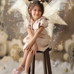 Every child deserves to feel magical. With a touch of digital artistry, we added glowing fairy wings to this portrait, transforming a sweet smile into an enchanting moment.