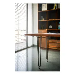 A detail shot of our studio workstation table. The slender steel rods are not just decorative; they are woven to represent the actual force diagrams of the structure, making the engineering itself the primary aesthetic feature. This is a core tenet of our design approach.
