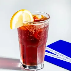 The Honey Tonic Brew is a refreshing mix of cold brew coffee and tonic water, sweetened with a touch of honey and garnished with lemon.