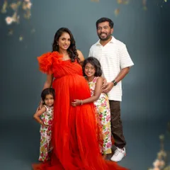 The whole family together. This beautiful portrait shows the parents with their two daughters, all embracing the baby bump, a perfect picture of a family growing with love.