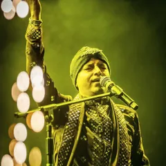 A moment of pure devotion. Our vocalist, with his hand raised in prayer, lost in the spiritual essence of the music.