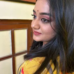 A side profile showing the soft pink eyeshadow and winged eyeliner from the festive makeover. This angle highlights the clean lines and blended colors that create an elegant and polished party look.