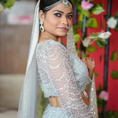 For a modern reception or engagement, a look like this is perfect. We chose a soft glam style with shimmery eyeshadow, a defined brow, and elegant diamond jewelry to match her stunning silver lehenga.