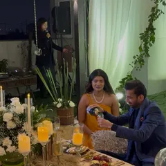 The moment of celebration after she said yes! The outdoor proposal setup included a romantic picnic, live music, and of course, champagne to toast to their future.
