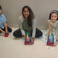 A birthday party that's out of this world! An instructor helps young explorers prepare their rockets for launch, making sure everyone is ready for the big moment.