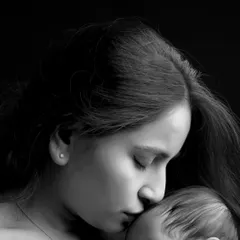 A detailed close-up shot capturing the quiet intimacy of a mother and her newborn. These macro shots are perfect for remembering the delicate features and peaceful moments of infancy.