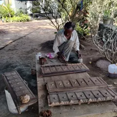 A craftsman meticulously restores an antique wooden door panel. This delicate process of stripping, repairing, and finishing by hand is essential to preserving the authentic character of a heritage property.