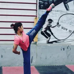 Flexibility is key to powerful kicks and avoiding injury. This student demonstrates an impressive high kick, showing the results of consistent stretching and conditioning.