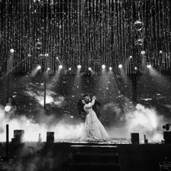 A timeless black and white shot capturing the couple's first dance. The dramatic lighting and smoke effects create a truly cinematic and romantic atmosphere for your performance.